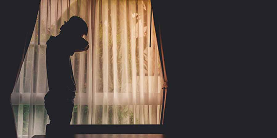 A dark room with an individual standing in it.
