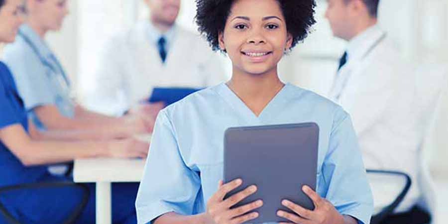 Nurse taking a CEU course on her tablet during lunch