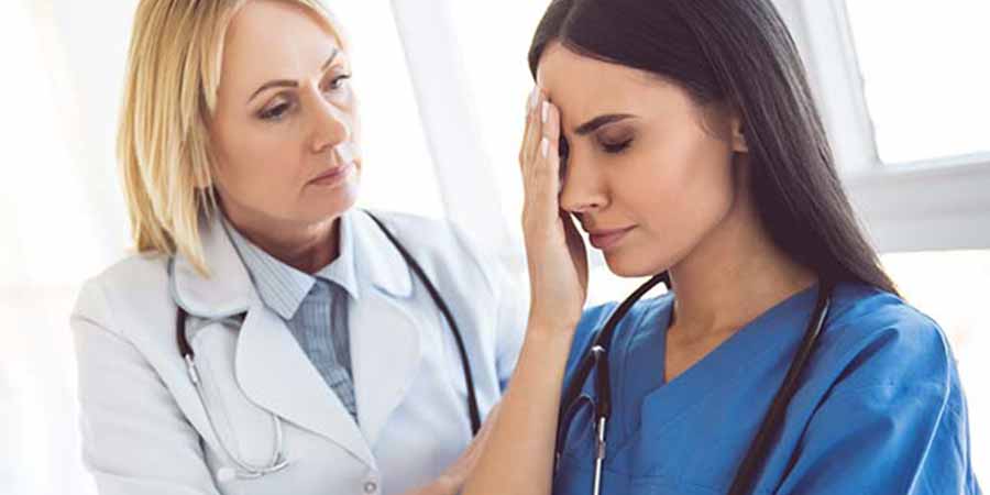 Nurse helping her companion with a stressful situation