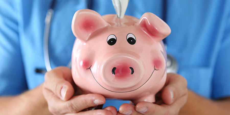 Nurse holding a piggy bank in her hands