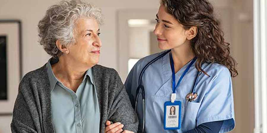 Nurse helping an elderly lady to walk